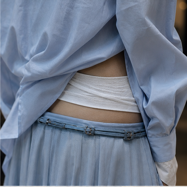 Close crop of pale blue and white layered waist styling