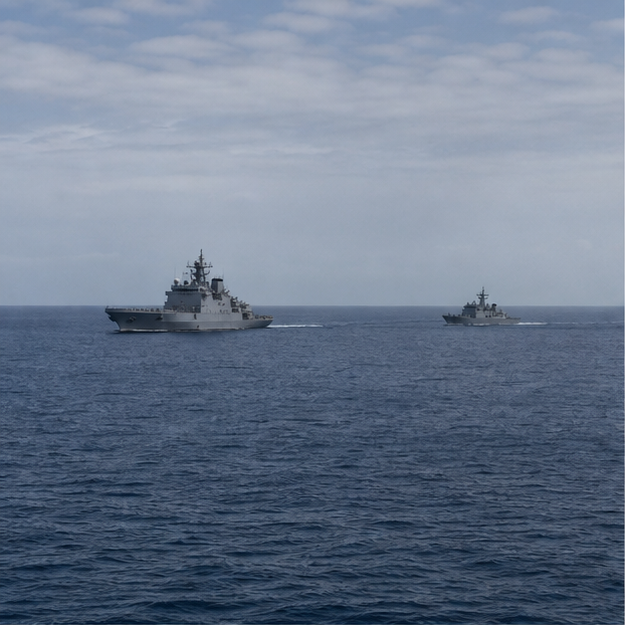 Two unmarked naval vessels operating in the open Pacific
