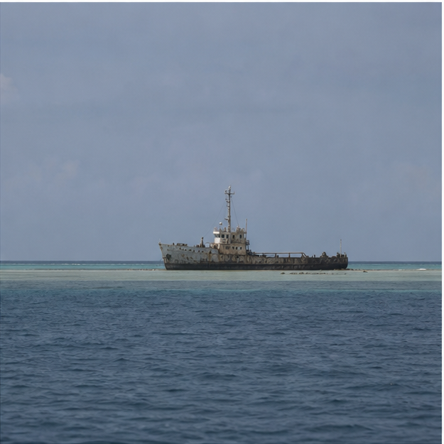 Old grounded vessel resting on a remote reef